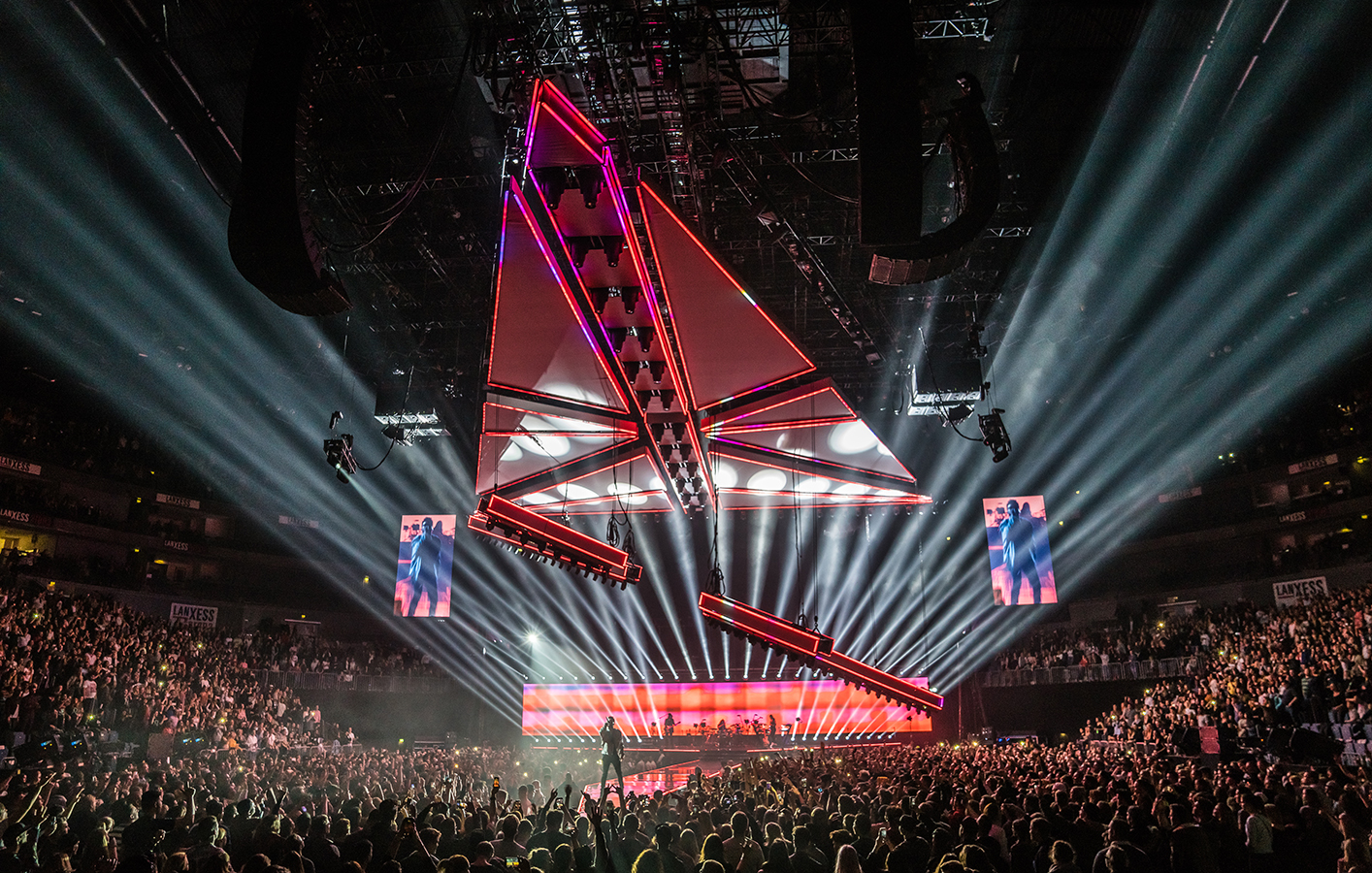 LED displays with red effects as the Weeknd plays to arena crowd