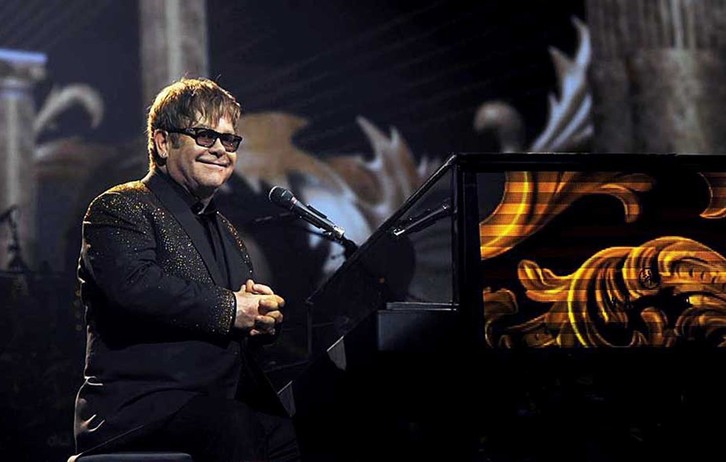 Elton John smiling towards crowd