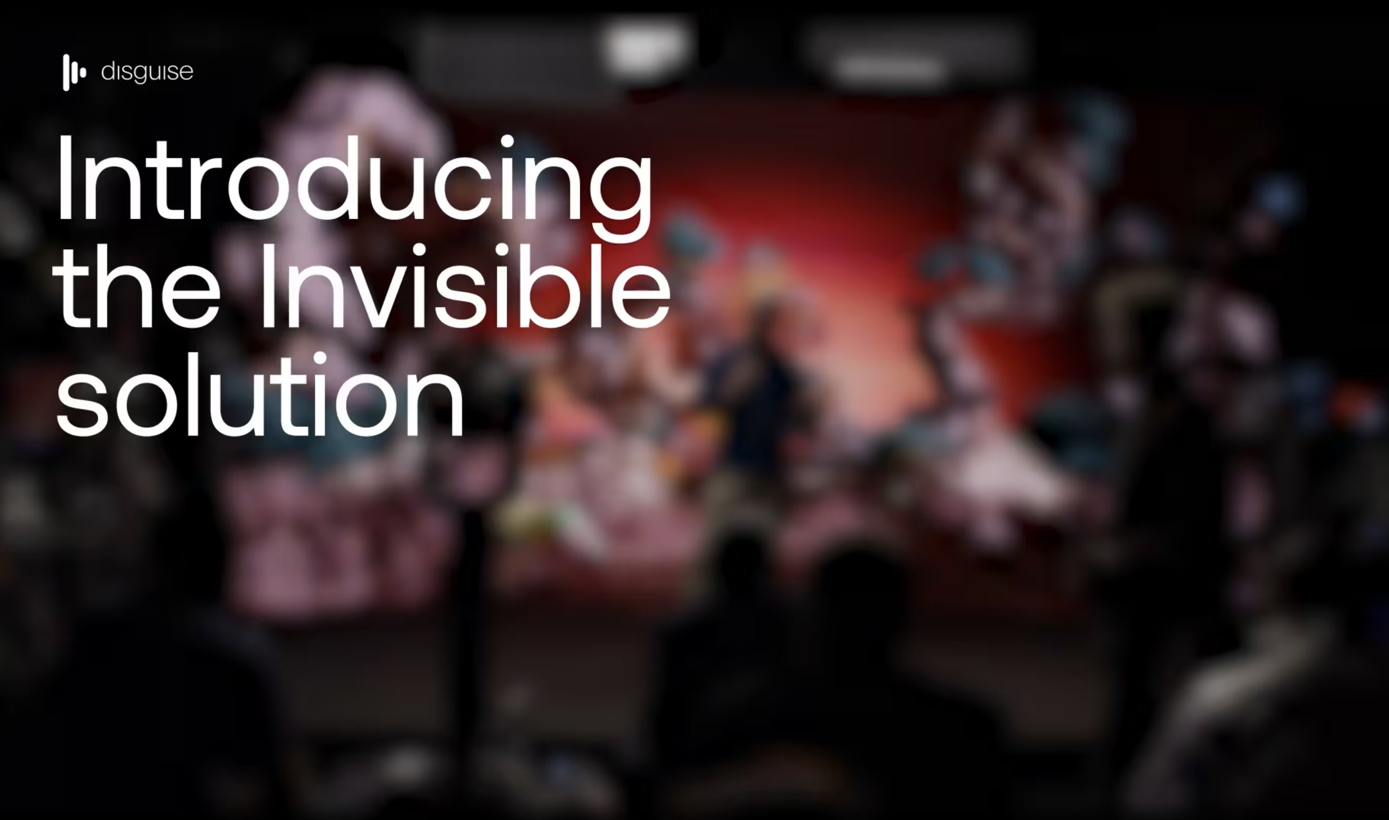 A still image of three people on an LED stage, with the title 'Introducing the Invisible Solution'
