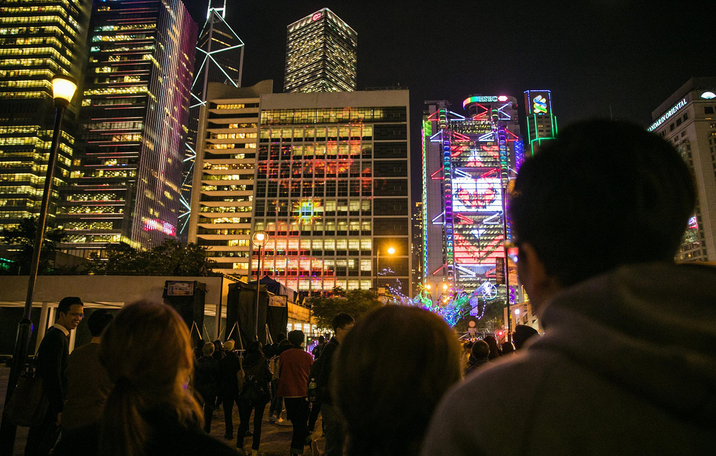 Crowd watches projection mapping and lighting display in Hong Kong