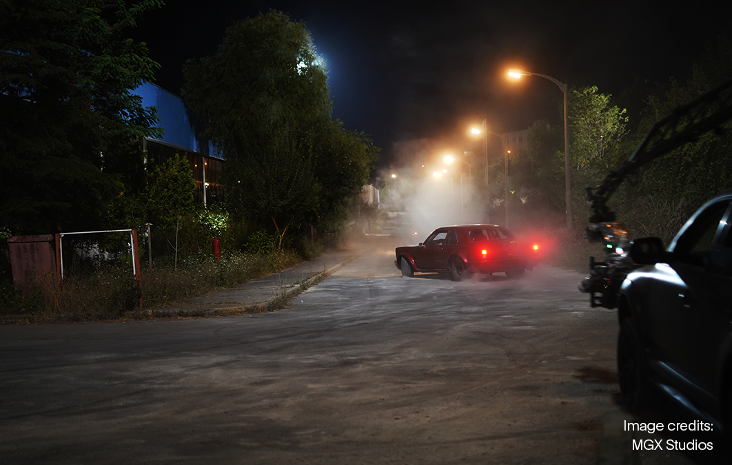 Car being filmed driving through nighttime scene