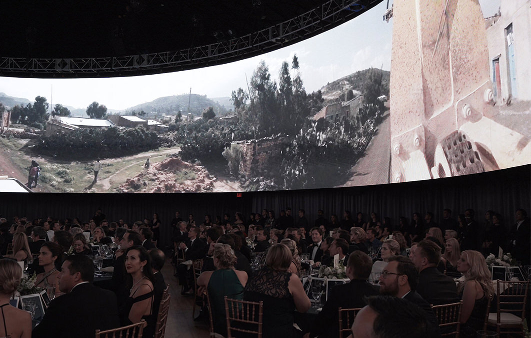 Crowd watches video on wrapped led screen