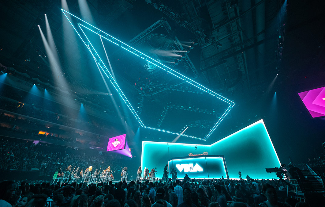 Stage from VMA awards with blue lighting and performers playing