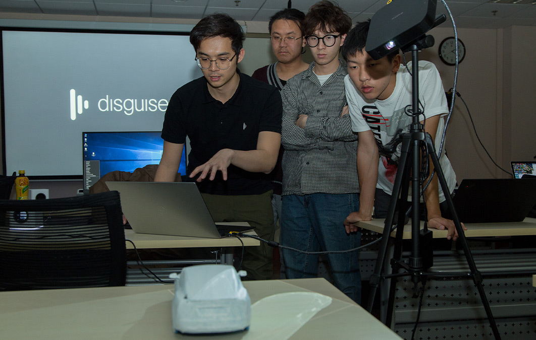 Group of people having discussion in front on laptop