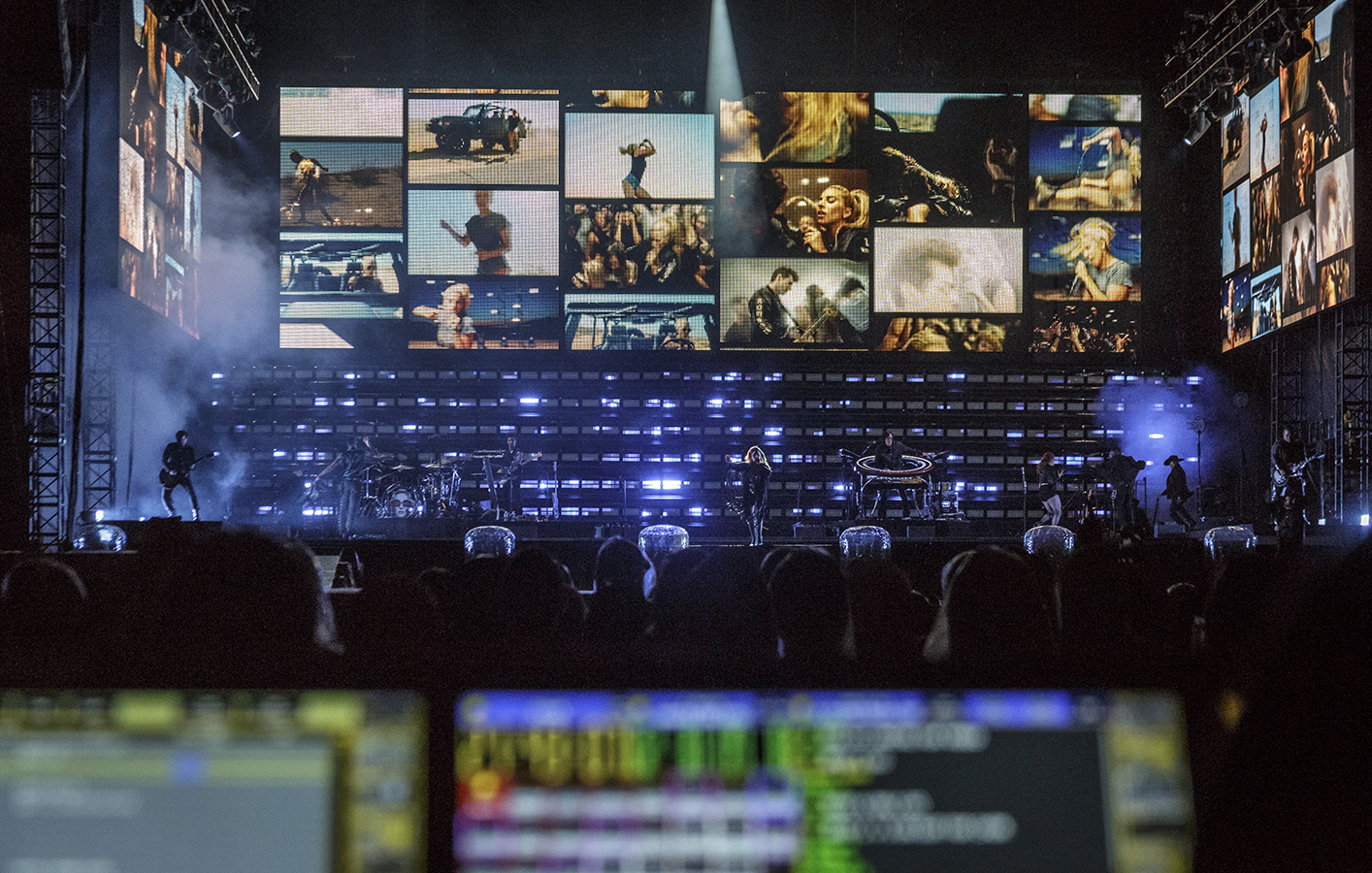 video displays show various scenes from a Lady Gaga music video