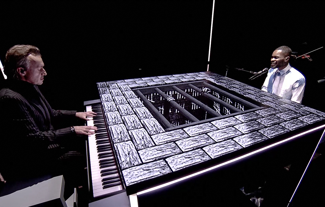 Dave plays piano and sings. Piano has effects projected on it. 
