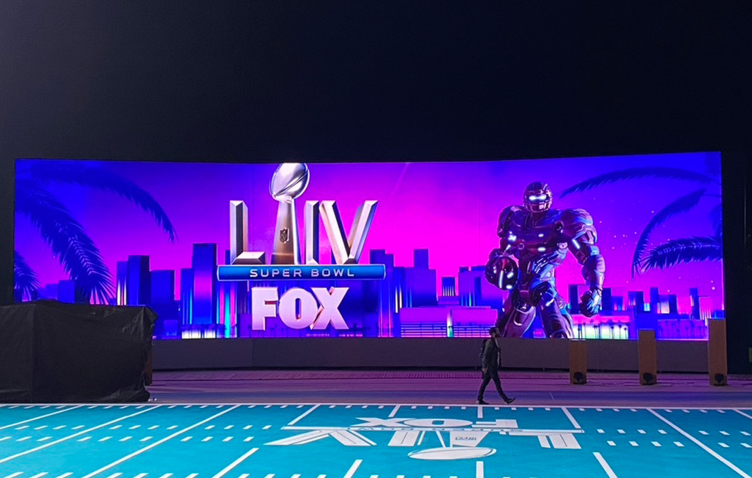 LED screen with design of robot holding NFL ball