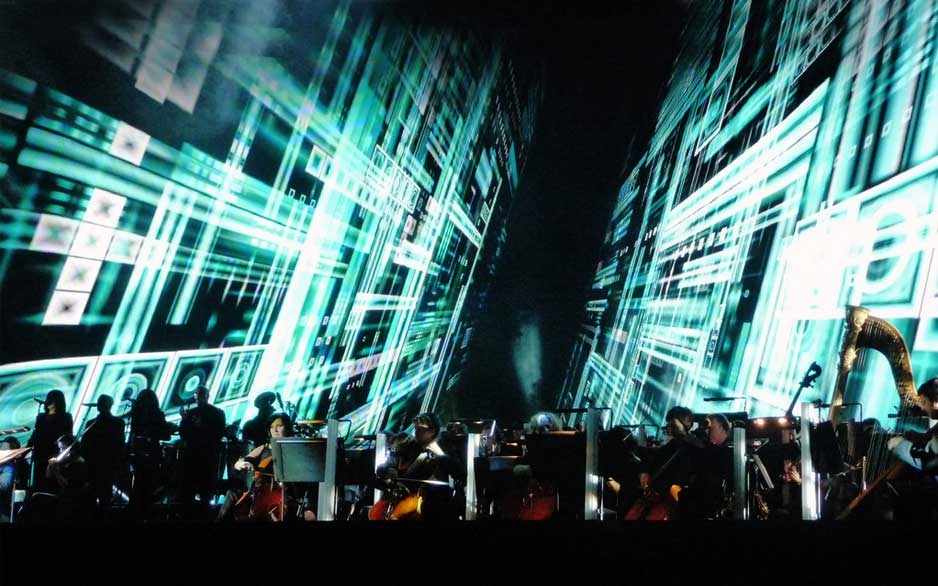 Orchestra performs in front of LED display 
