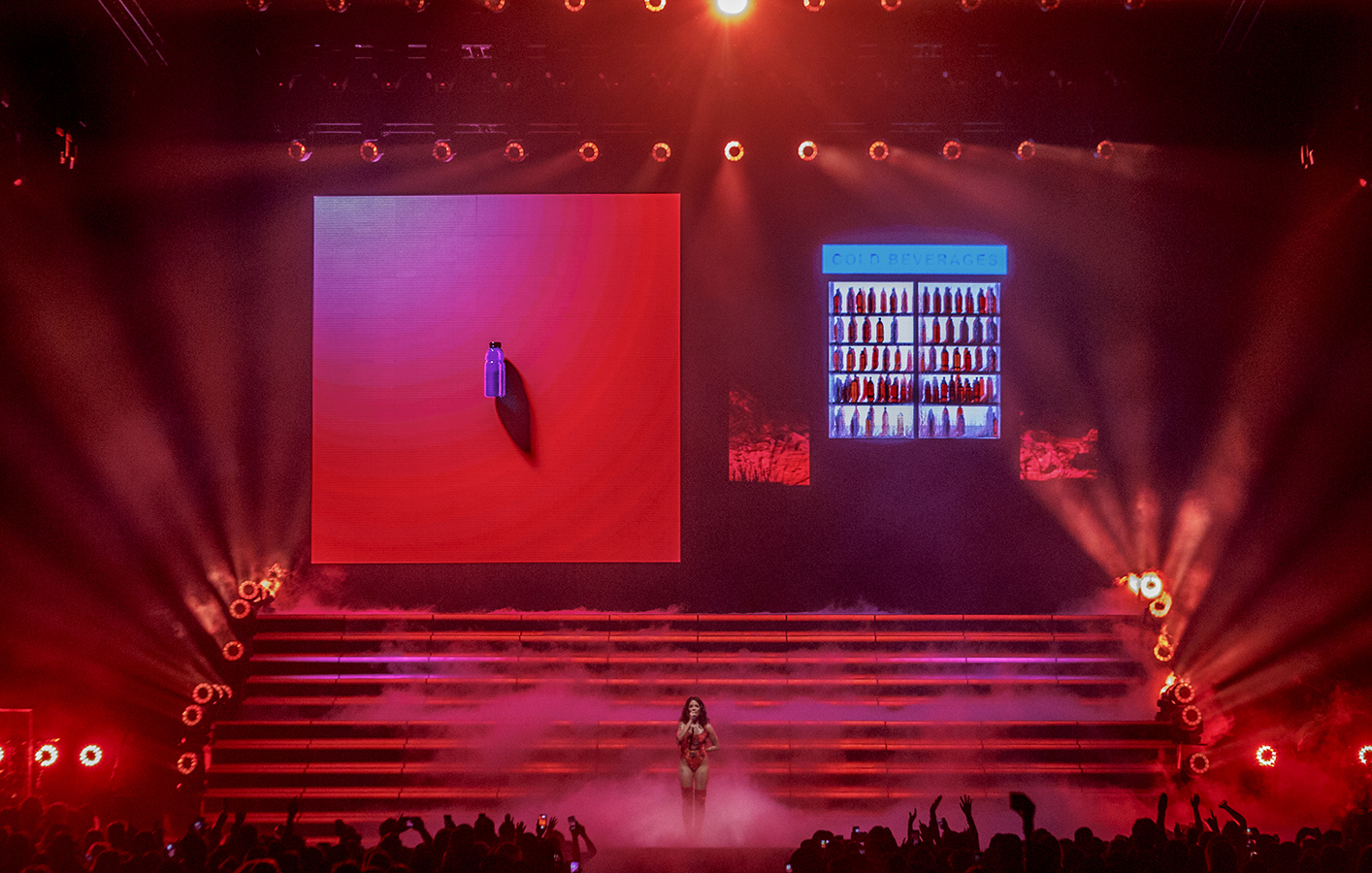 Halsey playing on a large stage with red lighting