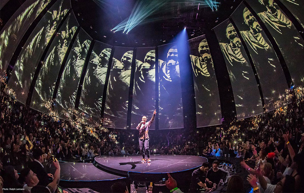 Justin Timberlake sings with curved screen design surrounding him