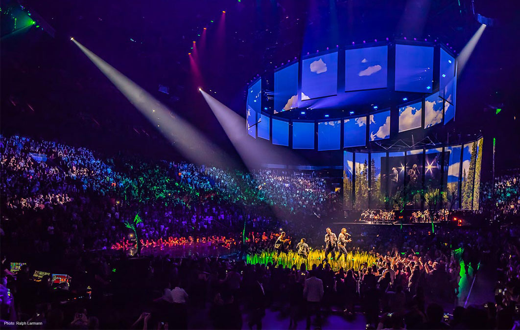 Justin Timberlake performs on stage in the middle of crowd