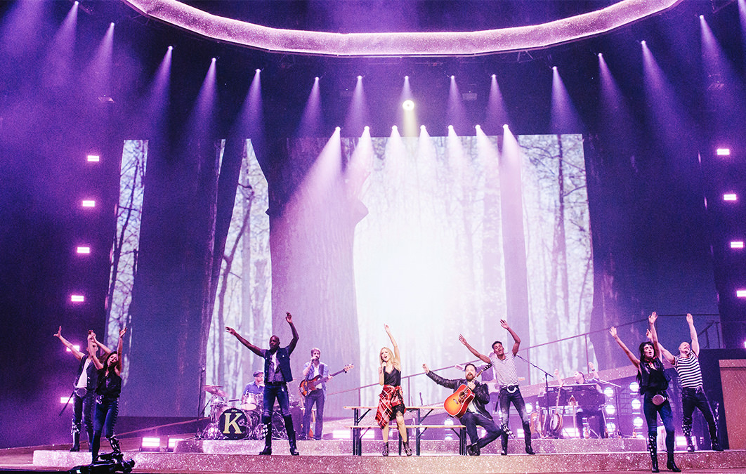 Kylie Minogue singing on stage with various performers