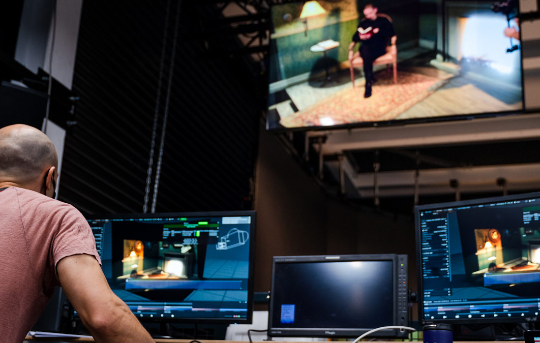 Operation team working on project of man reading on LED stage