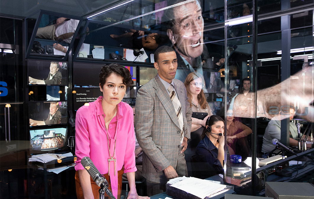 group of actors playing news producers and operators