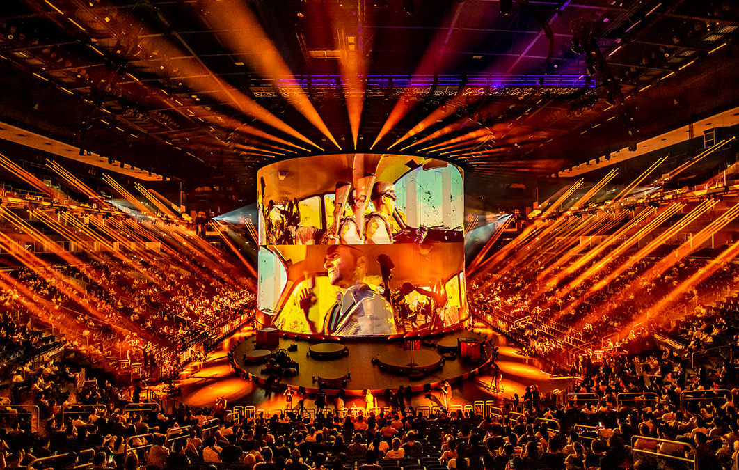 Large curved screen shows footage for western game