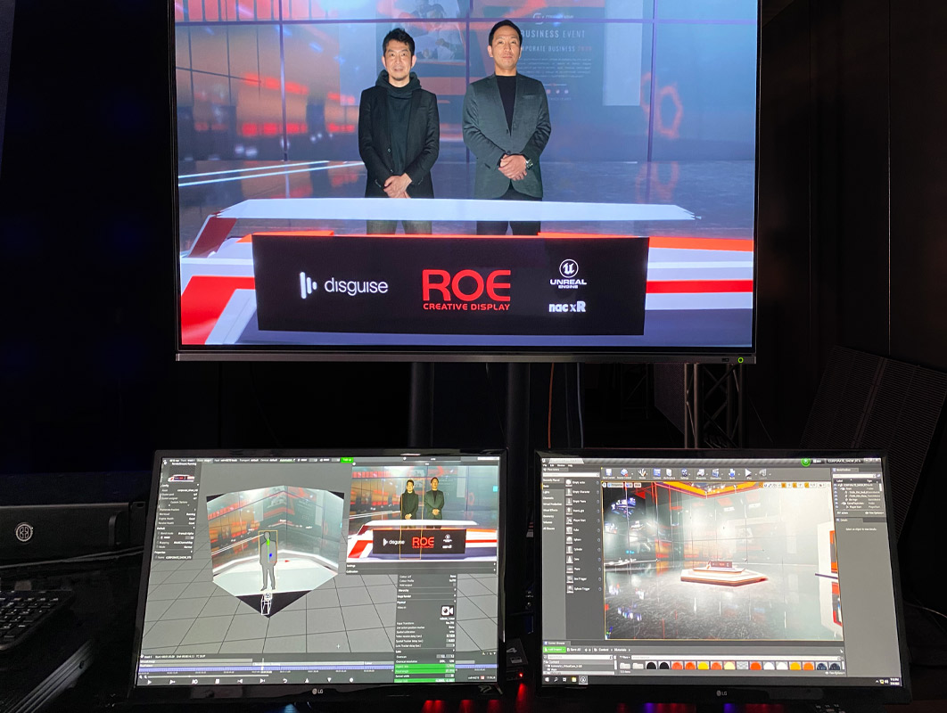 Two people presenting on Disguise and Roe branded LED stage