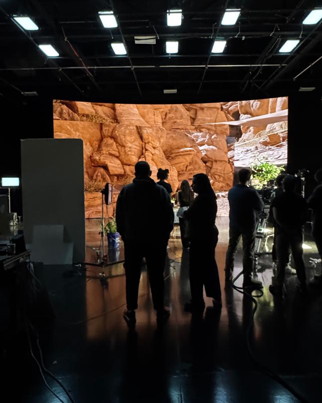 LED volume displaying a realistic 3D canyon environment with layered rock formations and desert lighting.