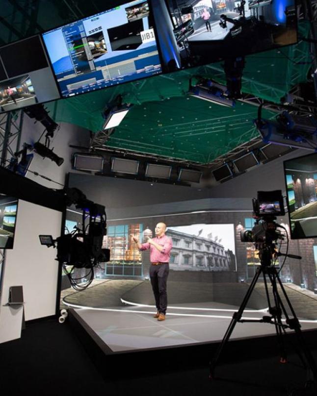 A person teaching from an LED Volume