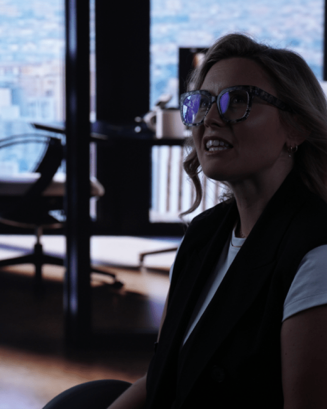 A person getting interviewed in front of an LED Volume with an office background.