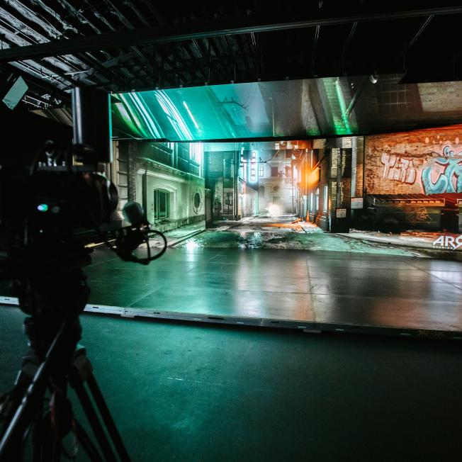 Dark urban alley created in Unreal Engine, displaying on an LED Volume