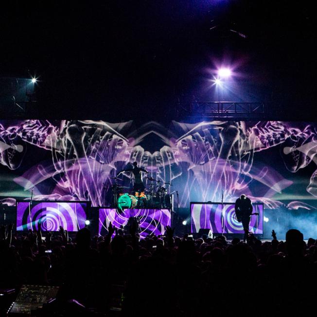 Skeletons are displayed across led screens as Blink 182 plays