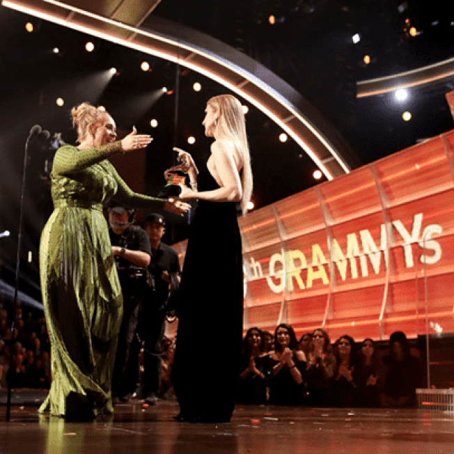 Adele embracing host at Grammys