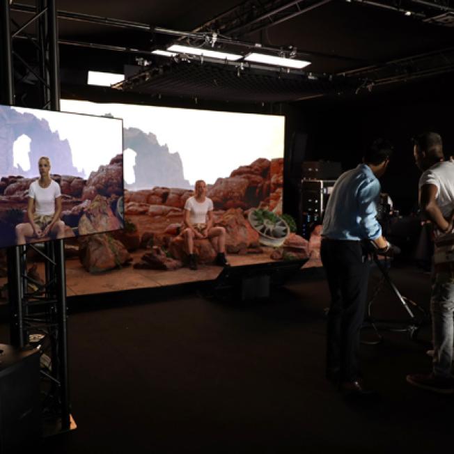two men filming a women on a virtual production stage. 