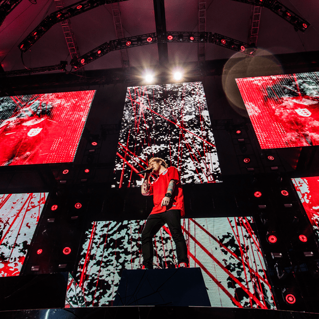 Ed Sheeran playing in front of multiple LED screens