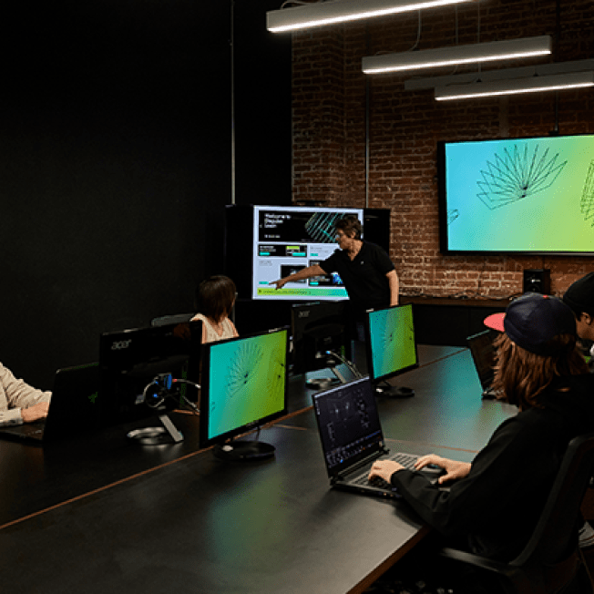 Group of students in meeting space for Disguise tutorial