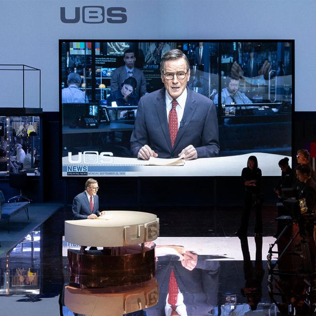 Bryan Cranston performing as news anchor on broadway theatre production