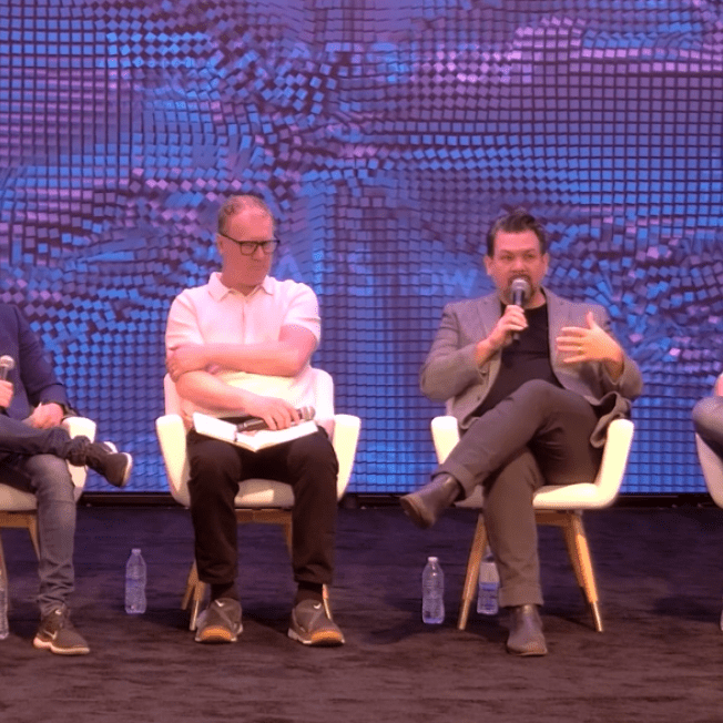 Speaker talks on panel at event
