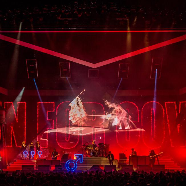 The killers playing live on stage with a various visual designs