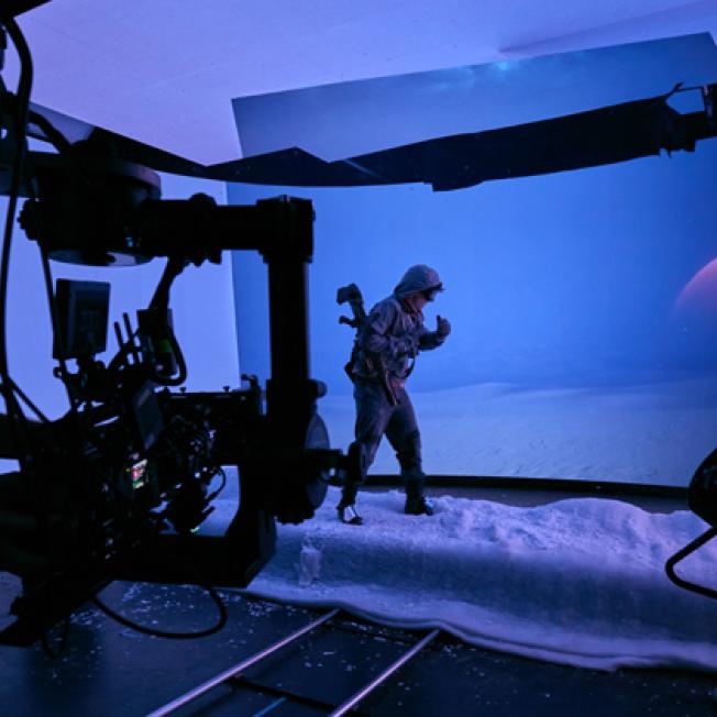 Man walking in snow suit on VP stage