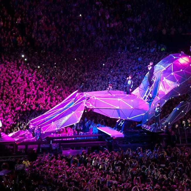 pop stars performing on stage designed as person
