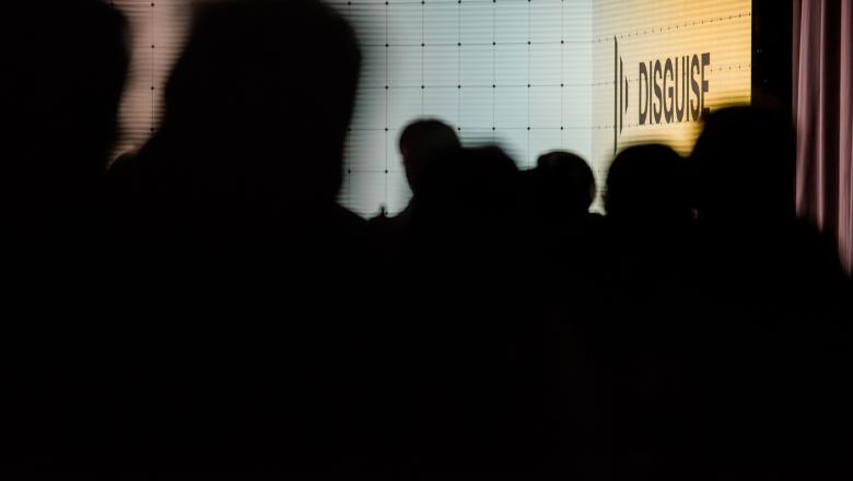 Outline of people at Disguise event