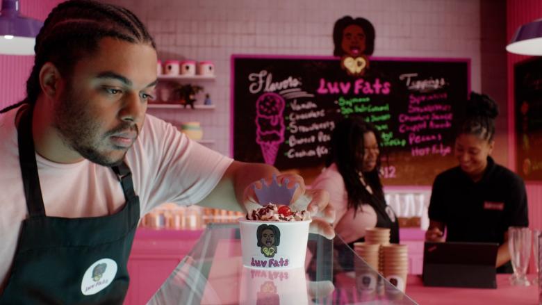 Man decorating ice cream cup in front of a virtual environment