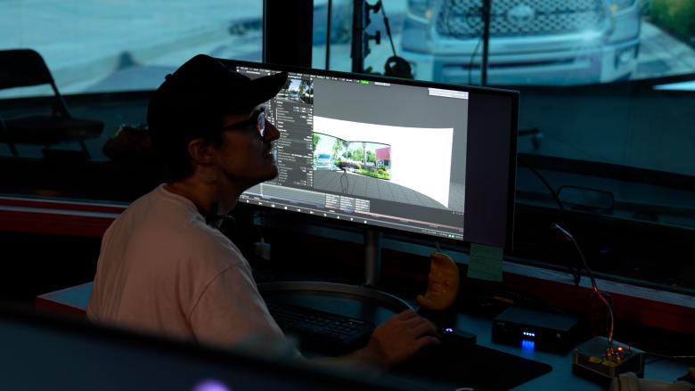 A student Florida State University’s virtual production studio is using Disguise Designer to previs the virtual environment on stage.