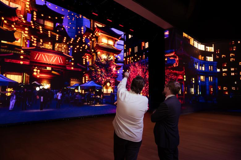 Two people discussing content on an LED wall