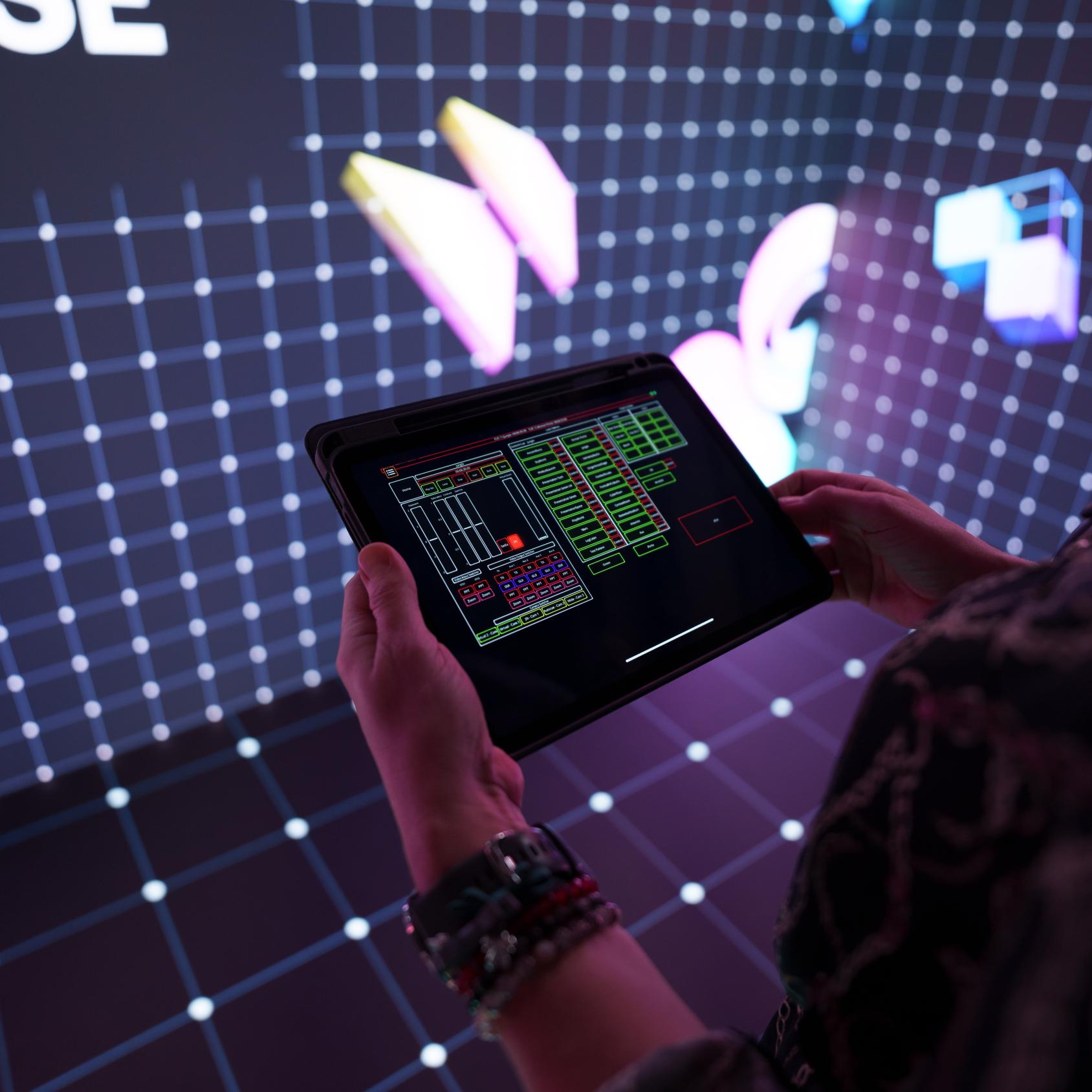 Person holding ipad with LED screen control functions