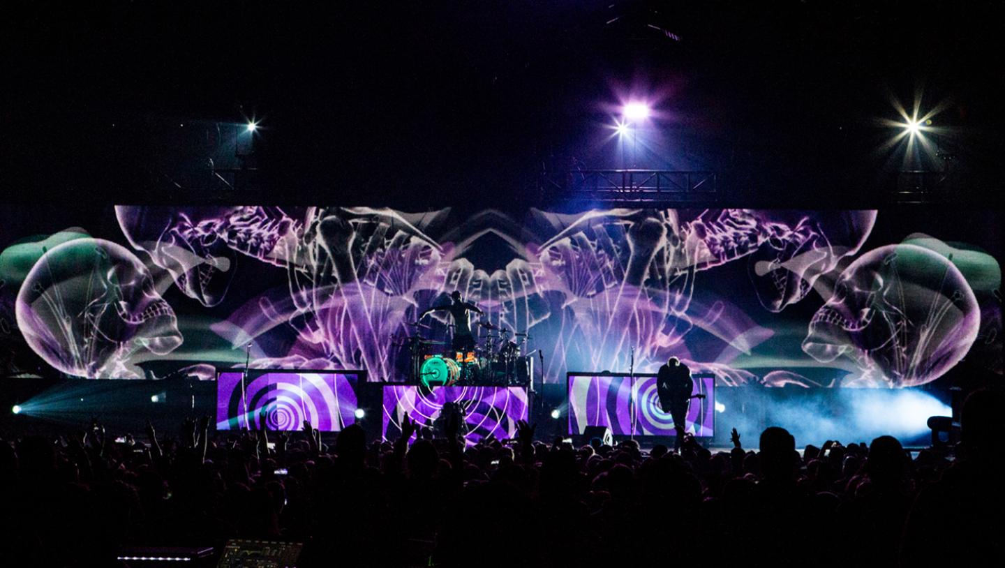 Skeletons are displayed across led screens as Blink 182 plays