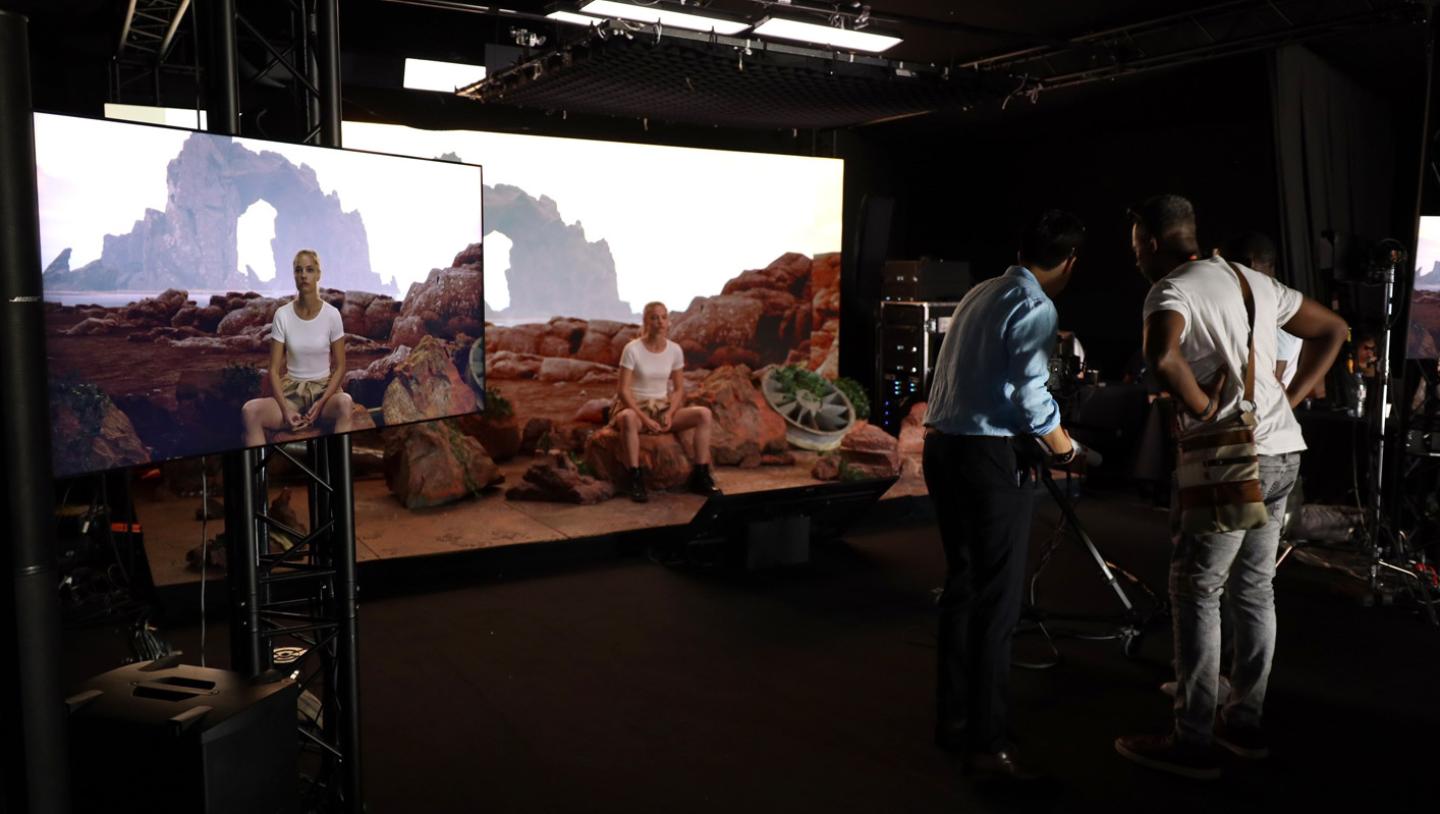 two men filming a women on a virtual production stage.