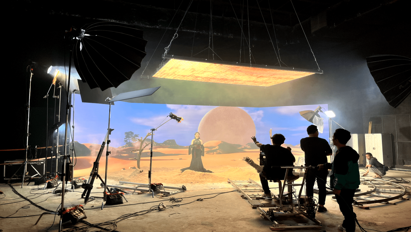 Virtual production stage of team shooting woman standing in desert