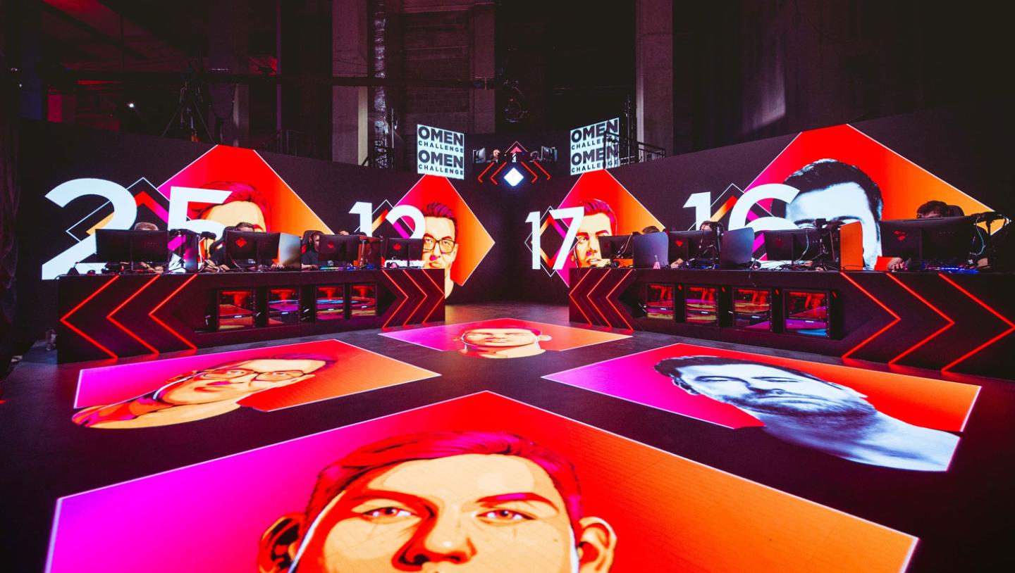 stage design for Omen esports event featuring players faces displayed on floor screens