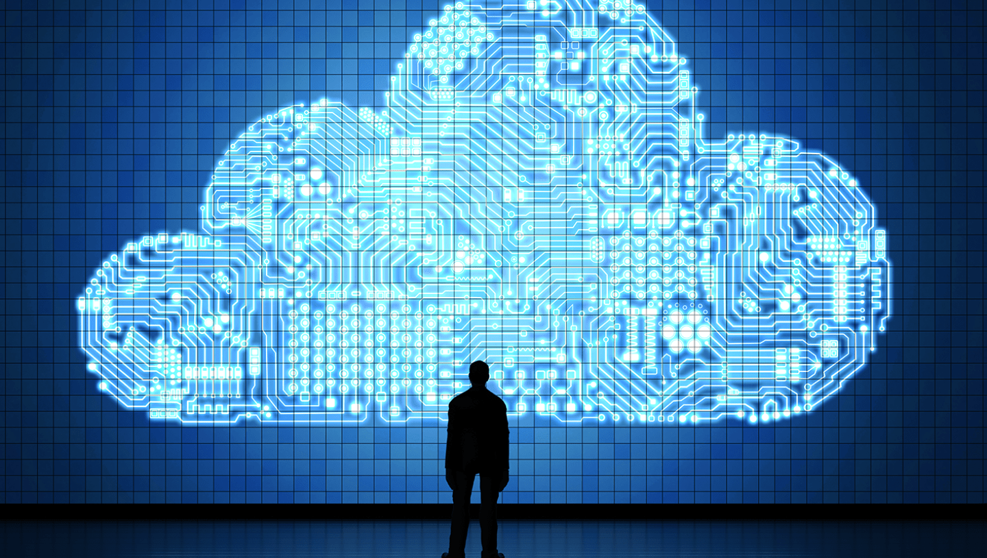 Man stands in front of cloud illustration on LED screen